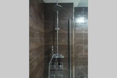 a shower with a glass door in a bathroom at Apartamento para 5 personas frente al mar con piscina y parking in Cubelles