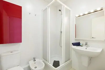 a bathroom with a shower and a toilet and a sink at Stay U-nique Apartments Urgell in Barcelona