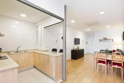 a kitchen and dining room with a table and a dining room at Stay U-nique Apartments Urgell in Barcelona