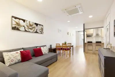a living room with a couch and a dining room at Stay U-nique Apartments Urgell in Barcelona