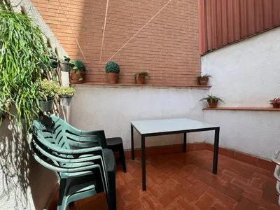 a table and chairs on a patio with plants at Stay U-nique Apartments Rogent in Barcelona