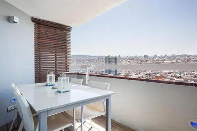a white table and chairs in a room with a view at Stay U-nique Apartments Sardenya in Barcelona