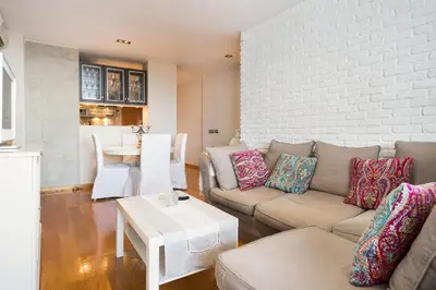 a living room with a couch and a table at Stay U-nique Apartments Sardenya in Barcelona
