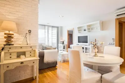 a living room with a table and a dining room at Stay U-nique Apartments Sardenya in Barcelona