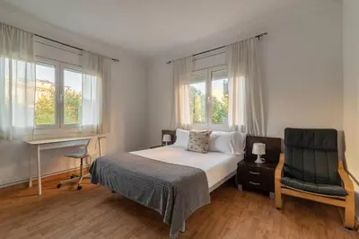 a bedroom with a bed and a desk and a chair at Stay U-nique Apartments Salva II in Barcelona