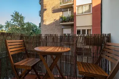 two wooden chairs and a table on a balcony at Stay U-nique Apartments Salva II in Barcelona