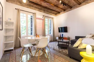 a living room with a table and a couch at Stay Unique Apartments Corsega in Barcelona
