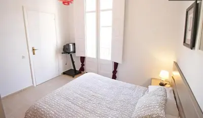 a white bedroom with a bed and a window at Sagrada Familia Apartamento eco friendly in Barcelona