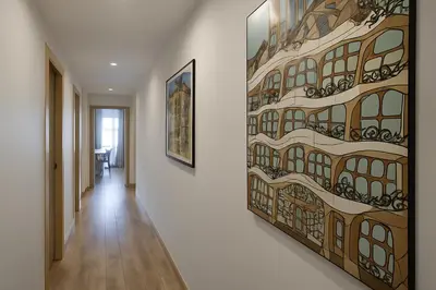 a hallway with a painting on the wall at Habitat Apartments Paseo de Gracia in Barcelona