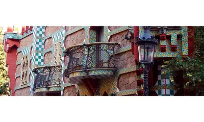 a brick building with balconies and a street light at Atic Gaudi-Gracia in Barcelona