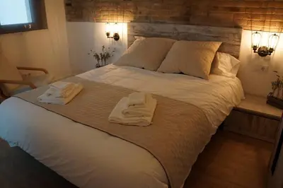 a bedroom with a large bed with towels on it at Barcelona Industrial Style Apartment in Hospitalet de Llobregat