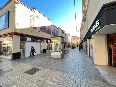 a street with many shops and a person walking down the street at New Camp Nou Apartment/Diret Airport,Beautiful in Hospitalet de Llobregat