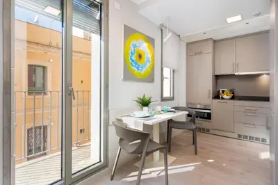 a kitchen and dining room with a table and chairs at Kronos on the beach Suite 2 in Barcelona