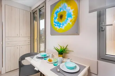 a kitchen with a table and a dining room at Kronos on the beach Suite 2 in Barcelona