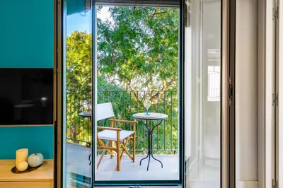 a glass door leading to a patio with a table at Kronos on the beach Suite 2 in Barcelona