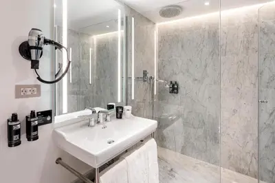 a bathroom with a sink and a shower at One Shot Aragó in Barcelona