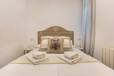 a bedroom with a bed with towels on it at Pere Serafi 2 bedroom apartment in Barcelona
