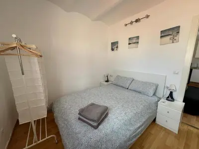 a bedroom with a bed with a gray blanket at Ático ideal en Barcelona in Barcelona