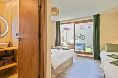 a bedroom with a bed and a window with a bike outside at Olivia Barcelona in Barcelona