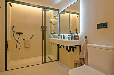 a bathroom with a shower with a sink and a toilet at Olivia Barcelona in Barcelona