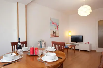 a dining room with a table and a television at Click&Flat Floridablanca in Barcelona