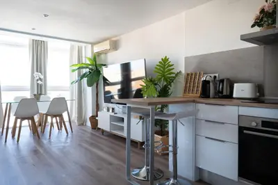 a kitchen with a counter and a table and chairs at Beach, Restaurants and Views in Castelldefels