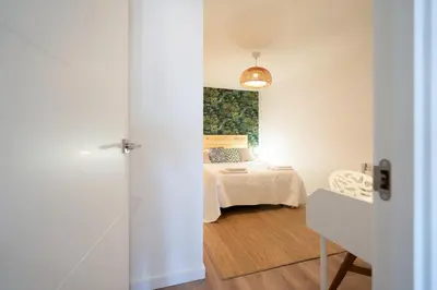 a bedroom with a bed with a painting on the wall at Beach, Restaurants and Views in Castelldefels