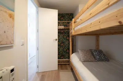 a small bedroom with a bunk bed and a closet at Beach, Restaurants and Views in Castelldefels