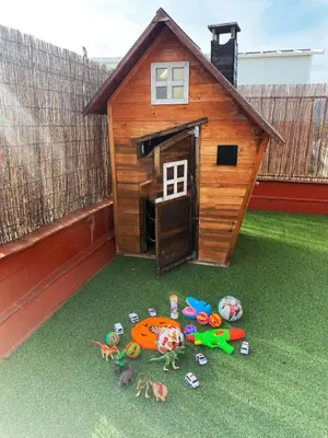 a toy dog house with toys on the grass at Beach, Restaurants and Views in Castelldefels