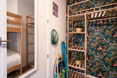 a room with a wall mural of tropical plants at Beach, Restaurants and Views in Castelldefels