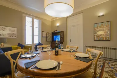 a dining room with a wooden table and chairs at Bcn Paseo De Gracia Rocamora Apartment in Barcelona