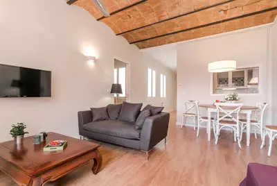 a living room with a couch and a table at Bcn Paseo De Gracia Rocamora Apartment in Barcelona