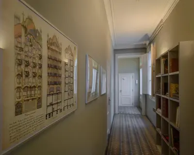 a hallway with posters on the walls of a building at Bcn Paseo De Gracia Rocamora Apartment in Barcelona