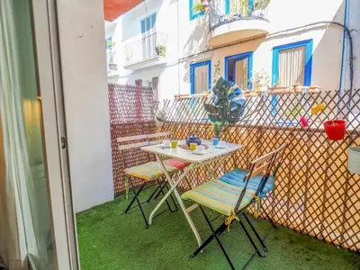 a small table and two chairs on a balcony at The Beach Holi Apartment by Hello Homes Sitges in Sitges