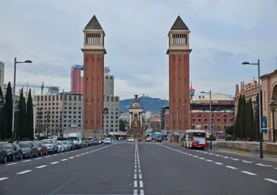 a street in a city with two towers and cars at Trip Barcelona Spain in Barcelona