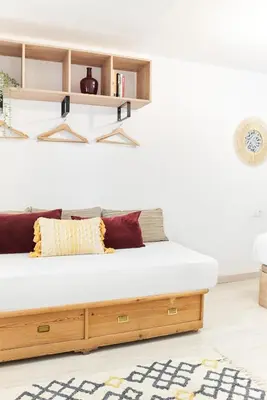 a bedroom with a wooden bed with shelves at HA Diputació terrace apartment in Barcelona