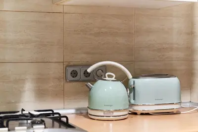 a tea kettle and toaster sitting on a stove at HA Diputació terrace apartment in Barcelona