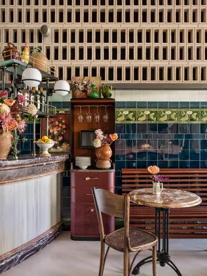 a restaurant with a table and chairs and a counter at Antiga Casa Buenavista in Barcelona