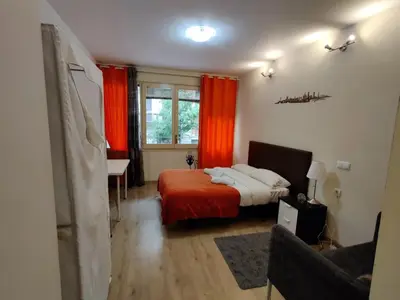 a bedroom with a bed with an orange blanket at Guest House Barcelona Bruc in Barcelona