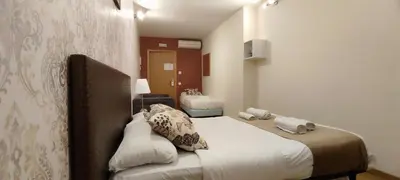 a hotel room with a bed and a bathroom at Guest House Barcelona Bruc in Barcelona