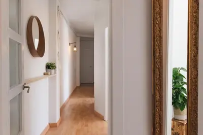 a hallway with a mirror on a wall at Sunny and modern apartment ideal for groups in Barcelona