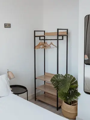 a bedroom with a black shelf next to a bed at Apartamentos Espai Progres by Be Barcelona in Hospitalet de Llobregat