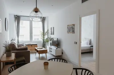 a living room with a table and a couch at Apartamentos Espai Progres by Be Barcelona in Hospitalet de Llobregat