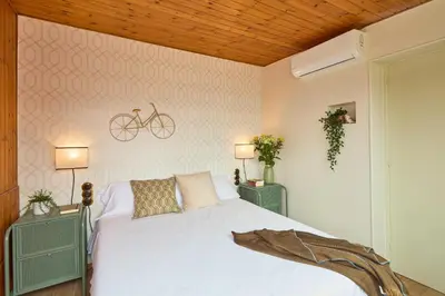 a bedroom with a bed with a bike on the wall at Casa Cosi - Industria in Barcelona