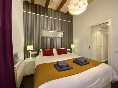 a bedroom with a bed with red pillows on it at Sant antoni apartment in Barcelona