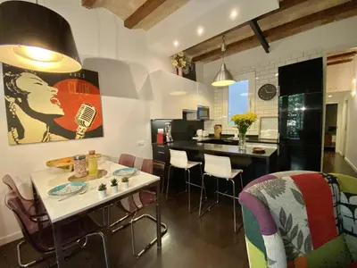 a kitchen and dining room with a table and chairs at Sant antoni apartment in Barcelona