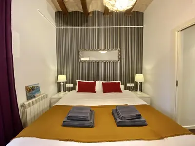 a bedroom with a bed with red pillows on it at Sant antoni apartment in Barcelona