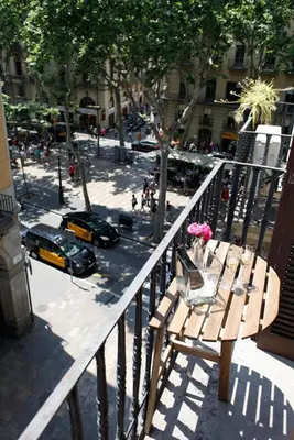 a balcony with a bench and a street with cars at Colom Apartments in Barcelona