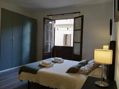 a bedroom with a bed with towels on it at Colom Apartments in Barcelona