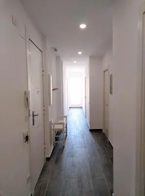 an empty hallway with a table and a window at Apartamentos Turísticos Tenor by Bossh! Hotels in Barcelona